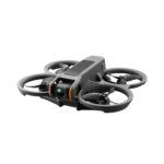 A sleek and compact DJI Avata 2 Fly More Combo drone with a gray body and an integrated camera at the front. The drone features ducted propellers for enhanced safety and stability, showcasing a modern design ideal for both indoor and outdoor use.