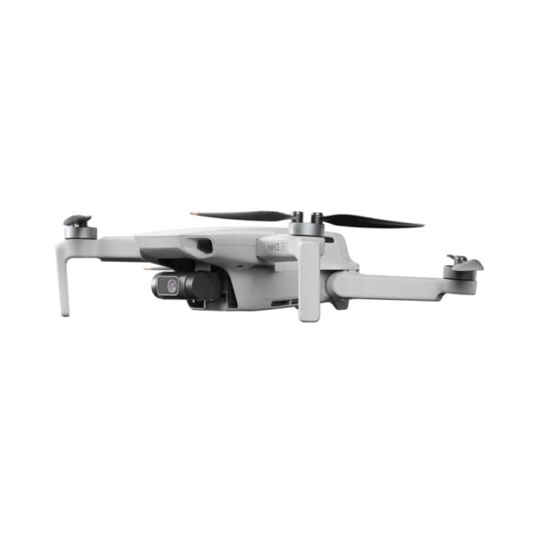 Side view of the DJI Mini 2 SE drone, featuring its compact and lightweight design with extended arms and propellers, and a gimbal-mounted camera for capturing high-quality aerial footage.