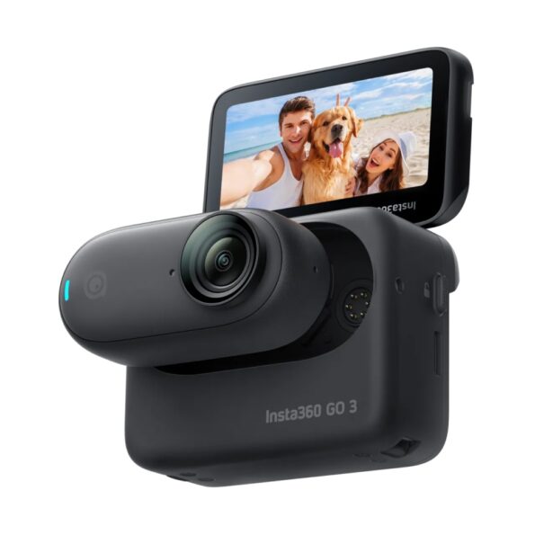 An Insta360 GO 3 action camera in black, featuring a compact design with a detachable lens module and a flip-up touchscreen display, showing a selfie image of two people and a dog on a sunny beach.