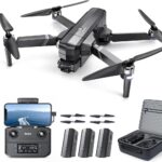 Ruko F11GIM2 Drone with 4K UHD camera, foldable design, remote control with smartphone holder, extra propellers, three rechargeable batteries, and a carrying case displayed in a comprehensive kit.